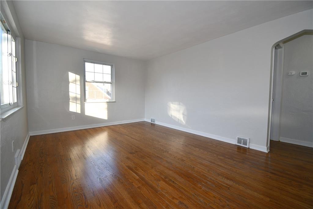 217 Oaklyn Road Bethel Park, PA 15102 - Photo 25 of 42 an empty room with wooden floor and windows