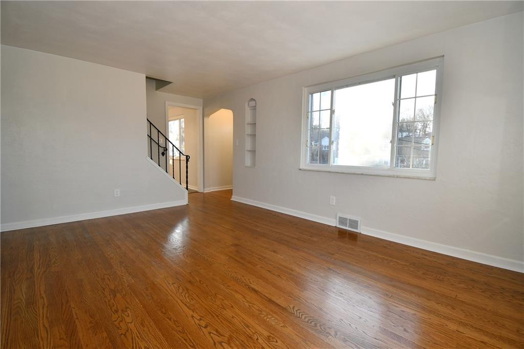 217 Oaklyn Road Bethel Park, PA 15102 - Photo 26 of 42 an empty room with wooden floor and windows