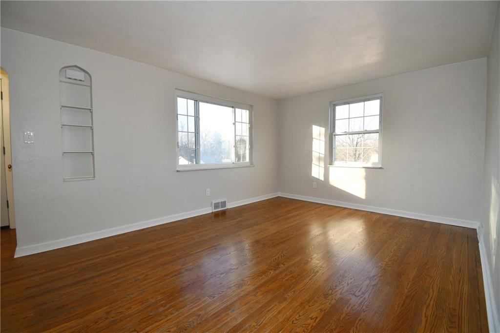 217 Oaklyn Road Bethel Park, PA 15102 - Photo 28 of 42 an empty room with wooden floor and windows