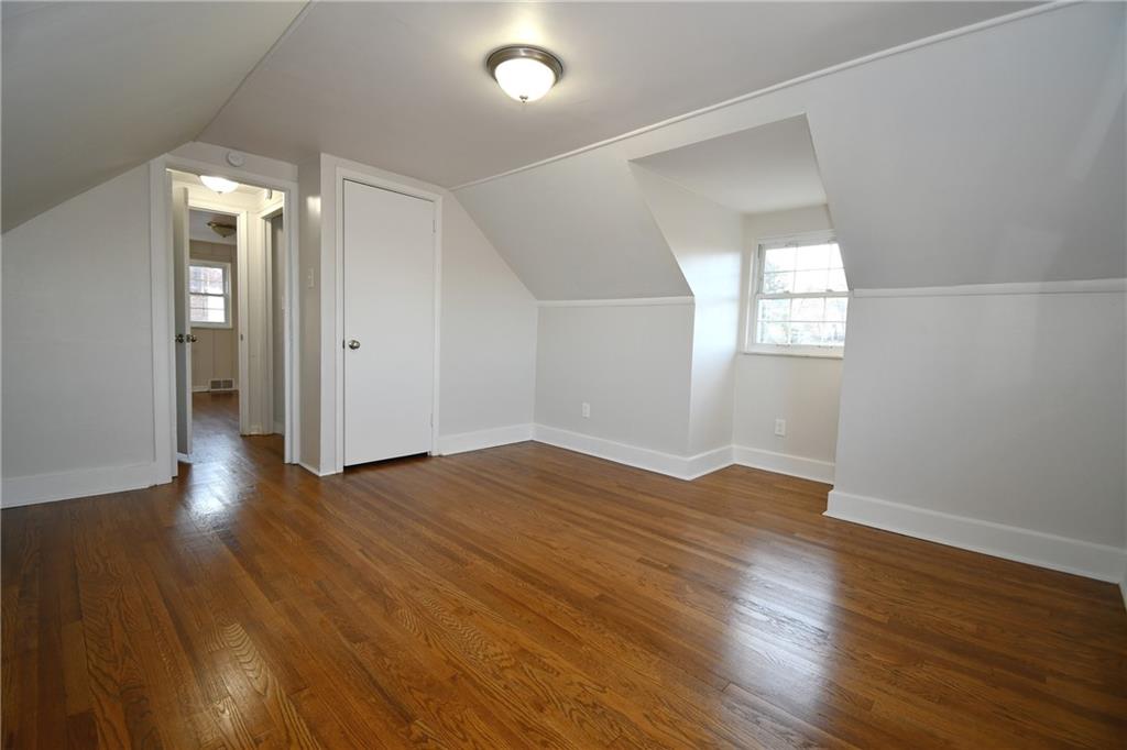 217 Oaklyn Road Bethel Park, PA 15102 - Photo 32 of 42 an empty room with wooden floor and windows