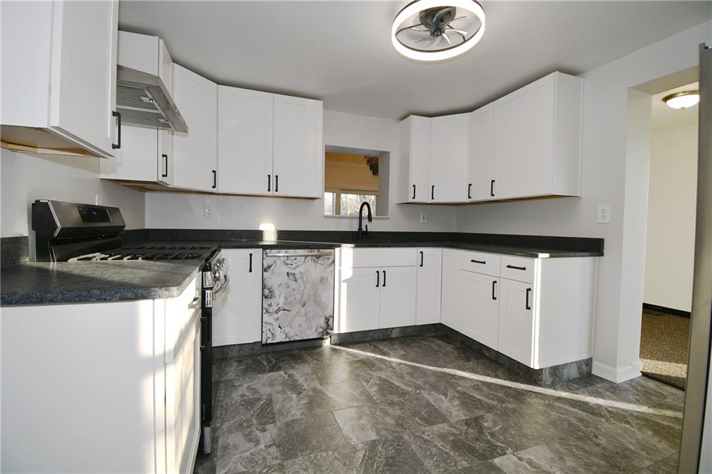217 Oaklyn Road Bethel Park, PA 15102 - Photo 6 of 42 a kitchen with granite countertop a sink a stove and cabinets