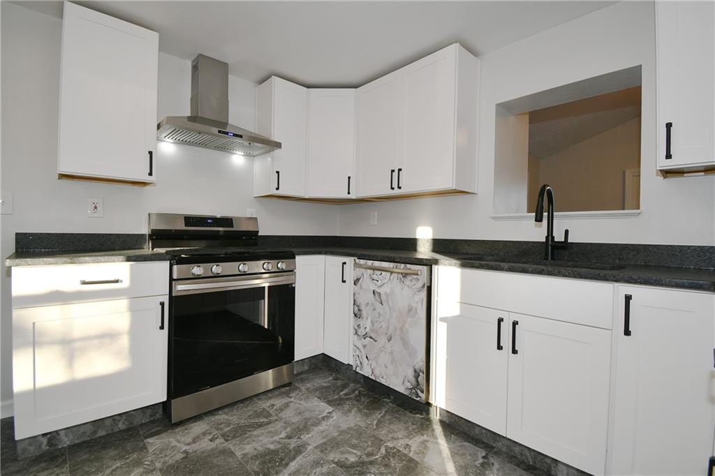 217 Oaklyn Road Bethel Park, PA 15102 - Photo 7 of 42 a kitchen with granite countertop a stove and a sink