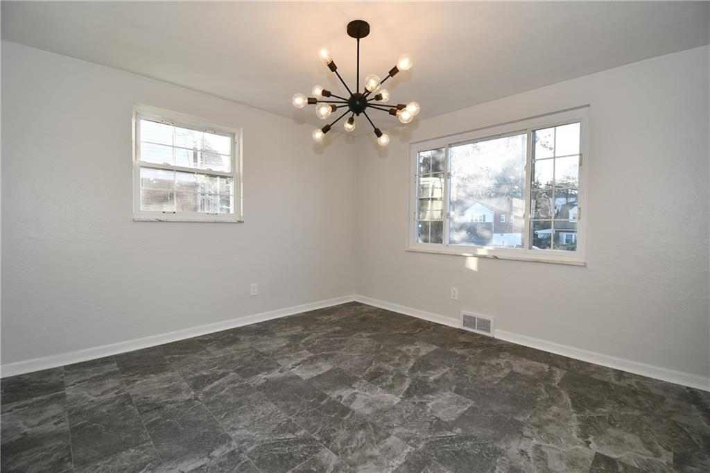 217 Oaklyn Road Bethel Park, PA 15102 - Photo 10 of 42 an empty room with windows and fan