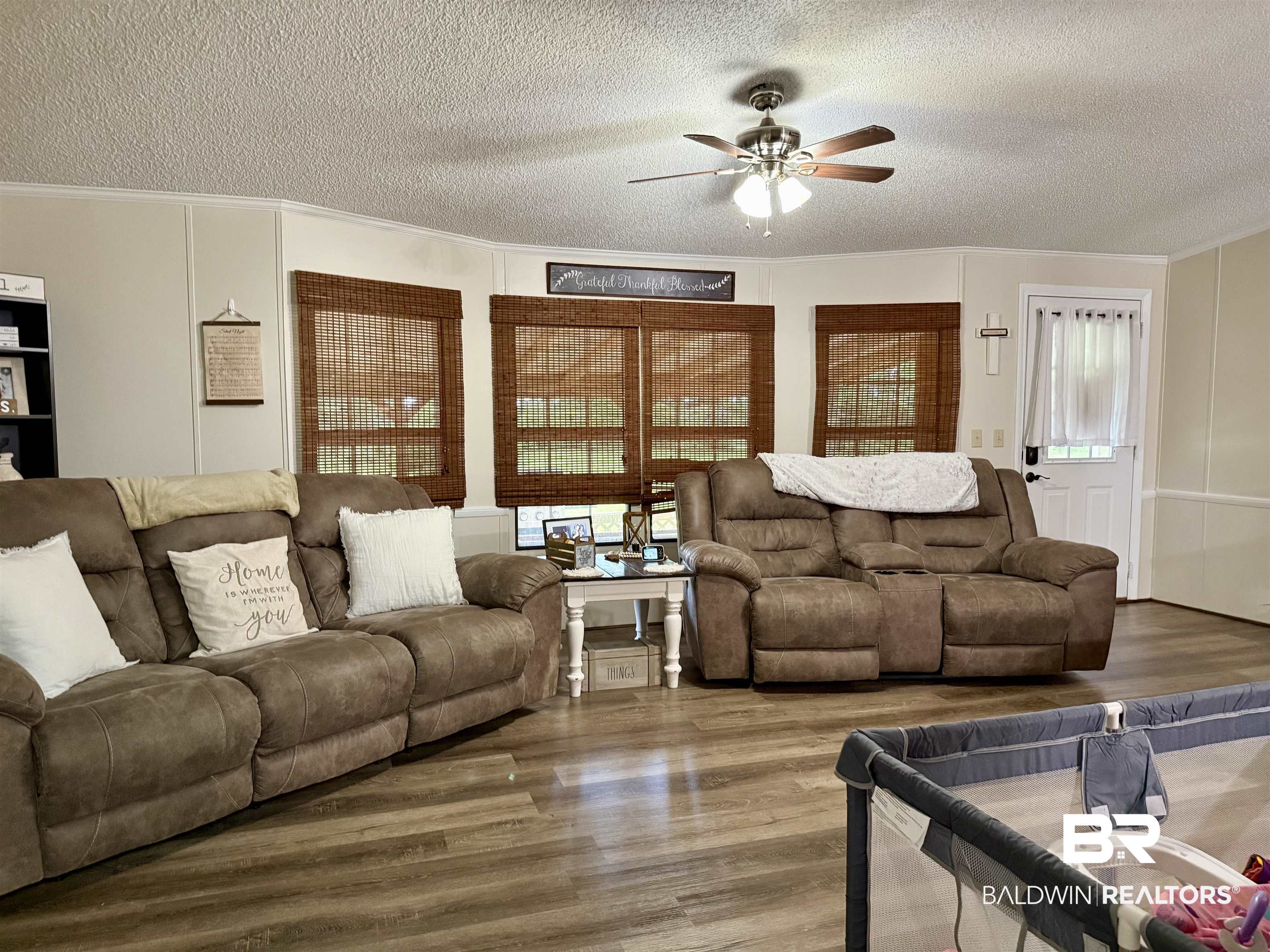 7577 Ridge Road Brewton, AL 36426 - Photo 2 of 24 Living room with a textured ceiling, ceiling fan, crown molding, and wood finished floors