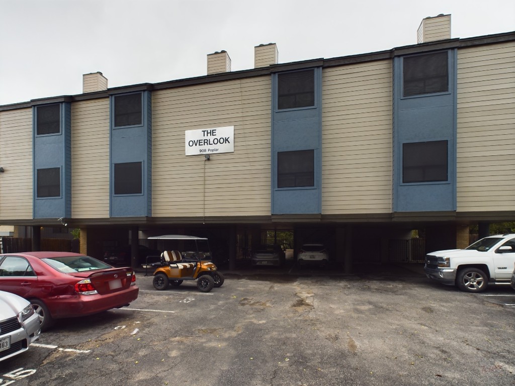 908 Poplar Street, Unit 201 Austin, TX 78705 - Photo 1 of 14 a view of a car park in front of house