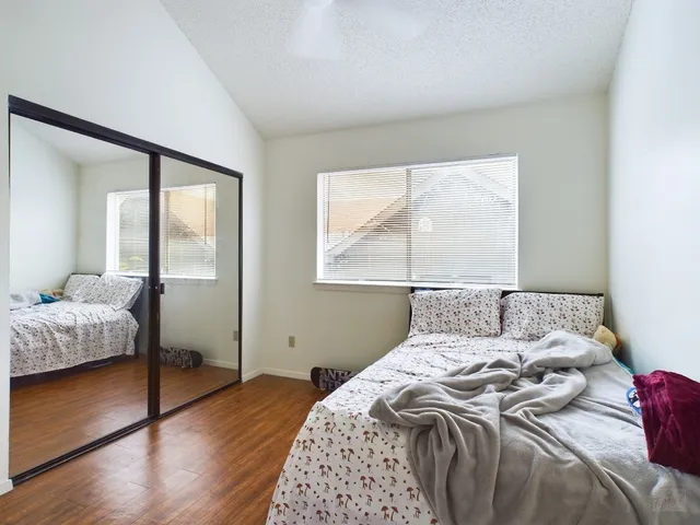 a bedroom with a bed and a window