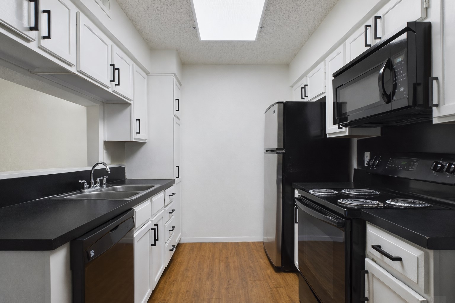 908 Poplar Street, Unit 201 Austin, TX 78705 - Photo 2 of 18 a kitchen with stainless steel appliances a sink stove and refrigerator
