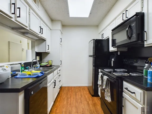 a kitchen with stainless steel appliances a stove cabinets and a refrigerator