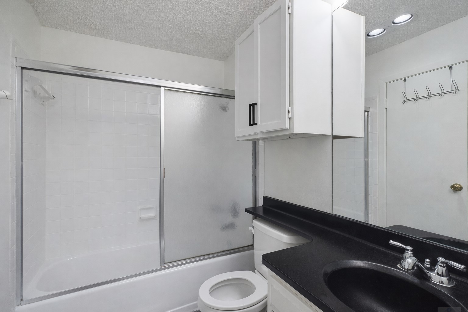 908 Poplar Street, Unit 201 Austin, TX 78705 - Photo 5 of 18 a bathroom with a sink and a mirror