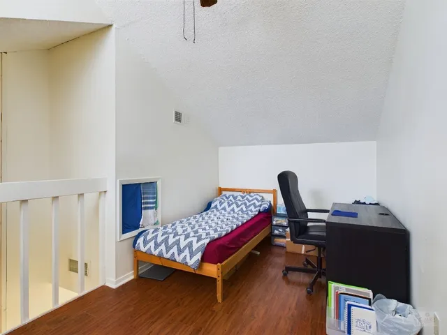 a bedroom with a bed and a desk