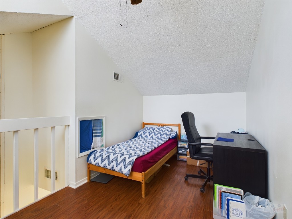 908 Poplar Street, Unit 201 Austin, TX 78705 - Photo 5 of 14 a bedroom with a bed and a desk