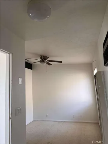 a view of a tree in the backyard of a house