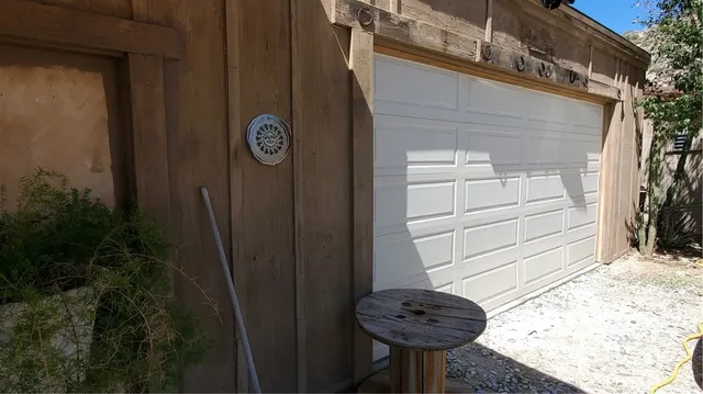 a large white kitchen with wooden floor