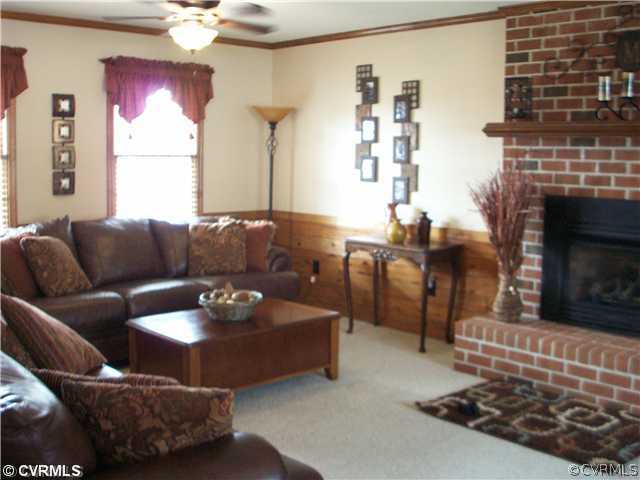 8244 White Oak Road Ford, VA 23850 - Photo 2 of 24 a living room with furniture and a fireplace