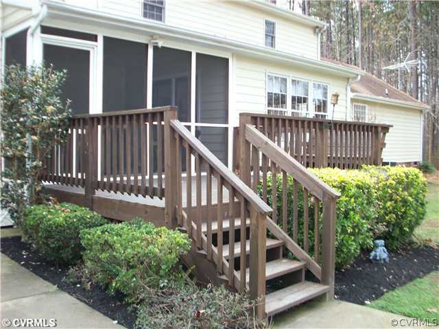 8244 White Oak Road Ford, VA 23850 - Photo 21 of 24 a view of a house with wooden deck and a small yard