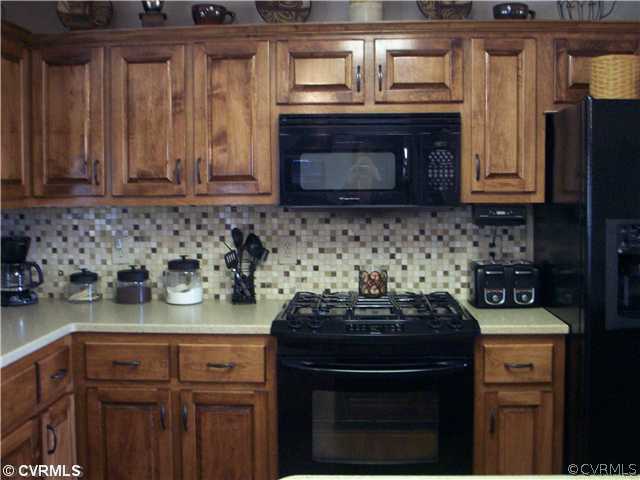 8244 White Oak Road Ford, VA 23850 - Photo 4 of 24 a kitchen with a stove a sink and cabinets