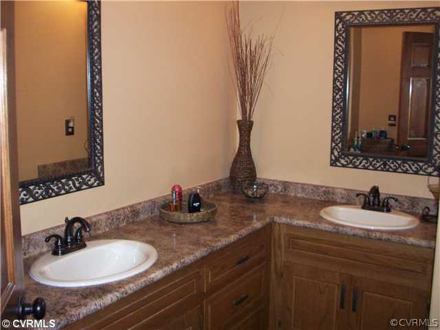 8244 White Oak Road Ford, VA 23850 - Photo 10 of 24 a bathroom with sinks double vanity and a mirror