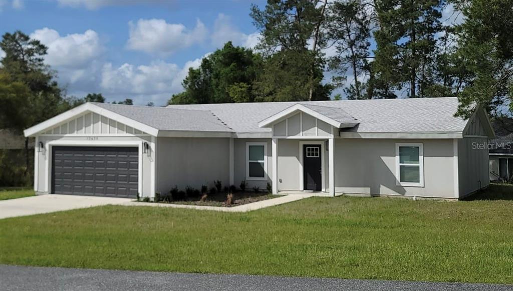 14896 Southwest 43rd Terrace Road Ocala, FL 34473 - Photo 1 of 1 a view of a white house with a small yard and large tree