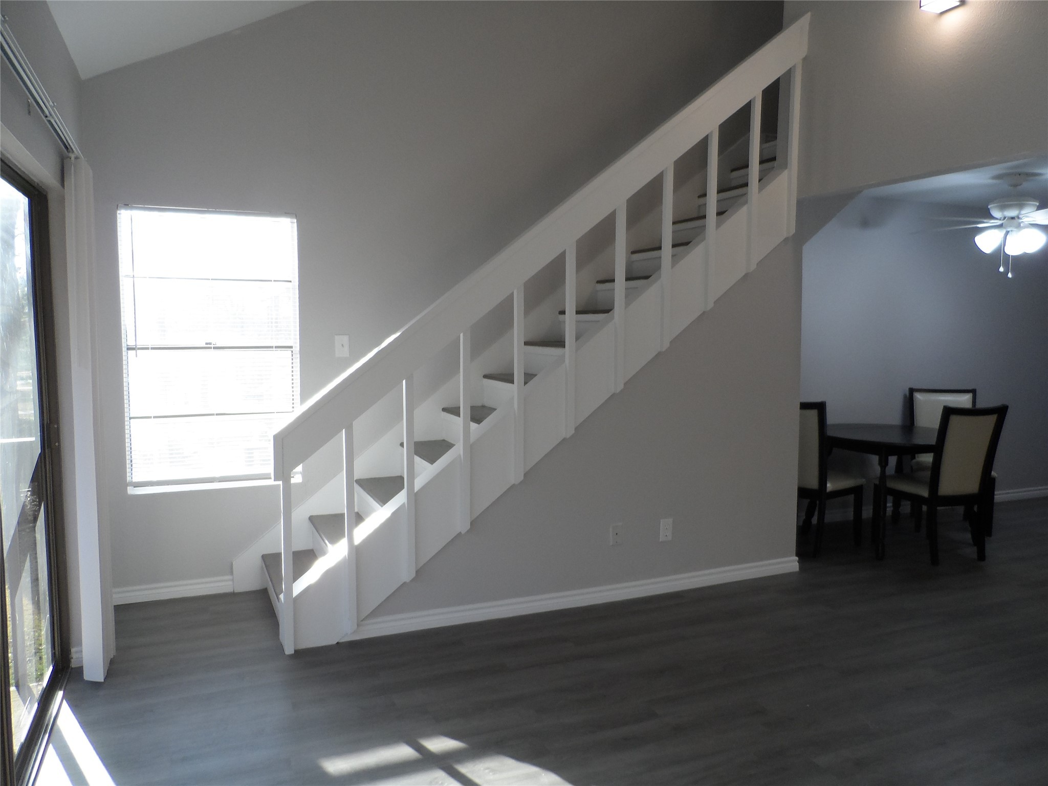 12900 Walden Road, Unit 618F Montgomery, TX 77356 - Photo 9 of 12 Open-concept layout with staircase overlooking the living area, adding architectural interest and natural light.