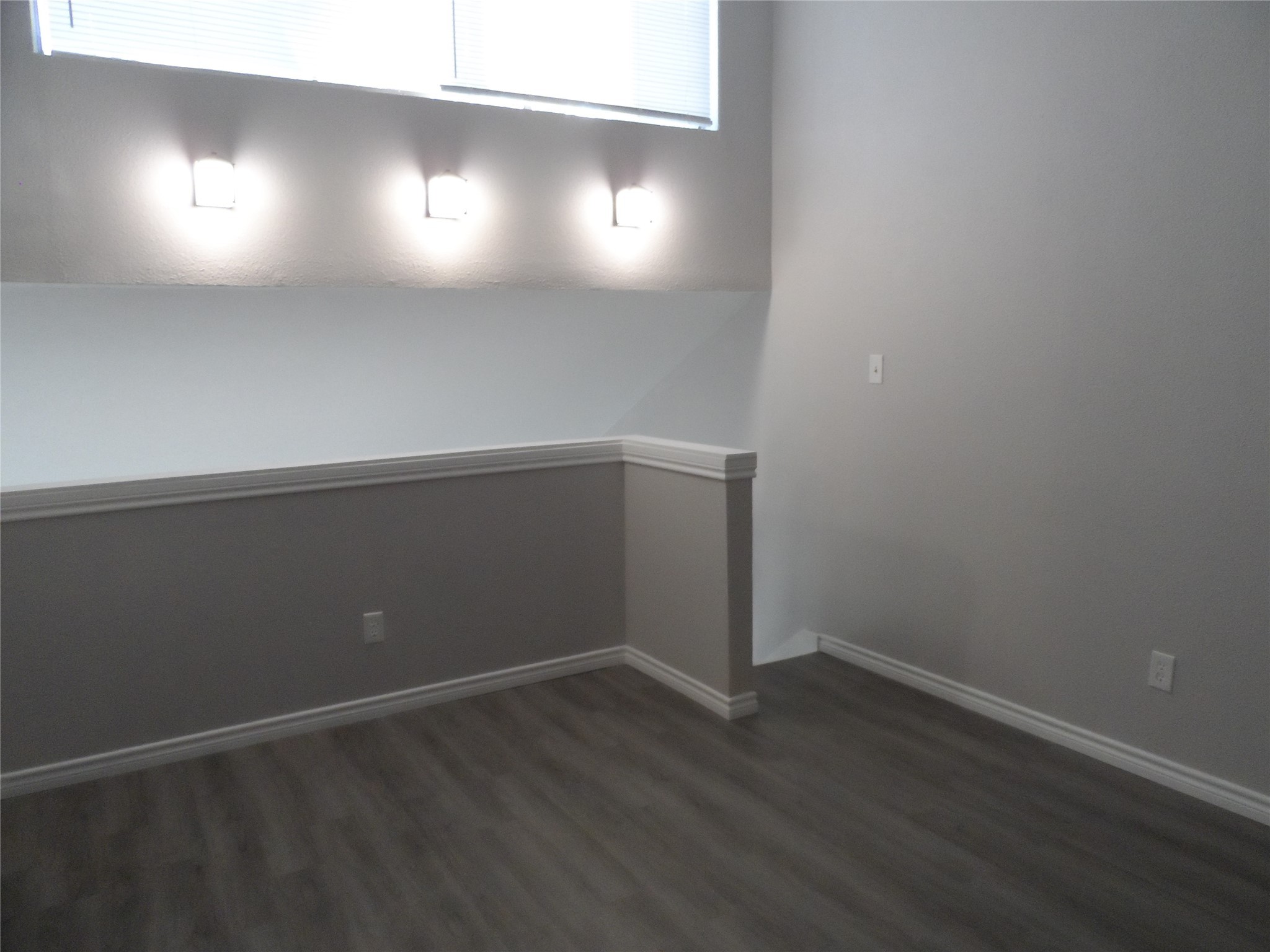 12900 Walden Road, Unit 618F Montgomery, TX 77356 - Photo 10 of 12 Upper-level living space with stylish wall sconces and natural light, ideal for a cozy retreat or workspace.