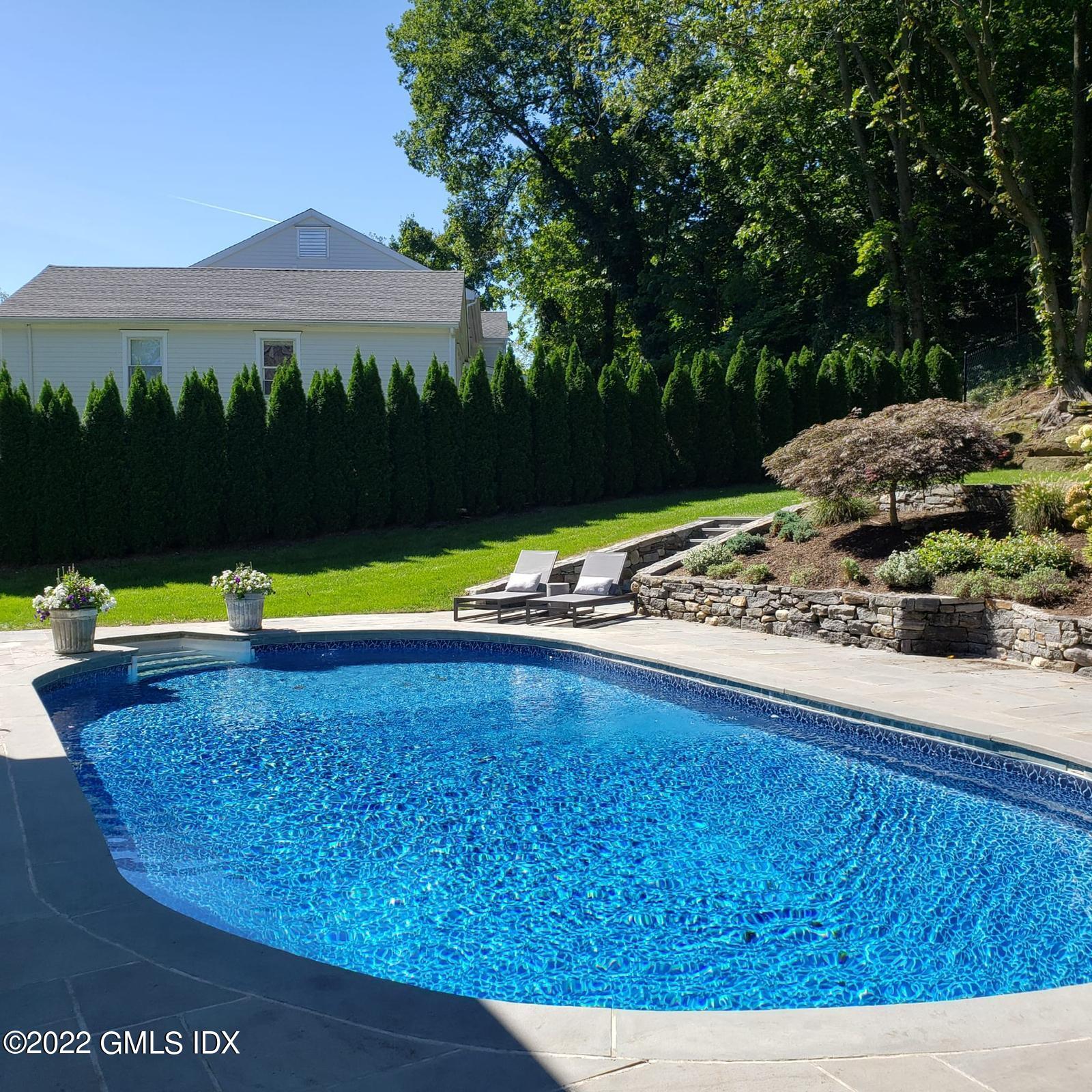 85 Mallard Drive Greenwich, CT 06830 - Photo 8 of 40 a view of a swimming pool with a yard and large tree