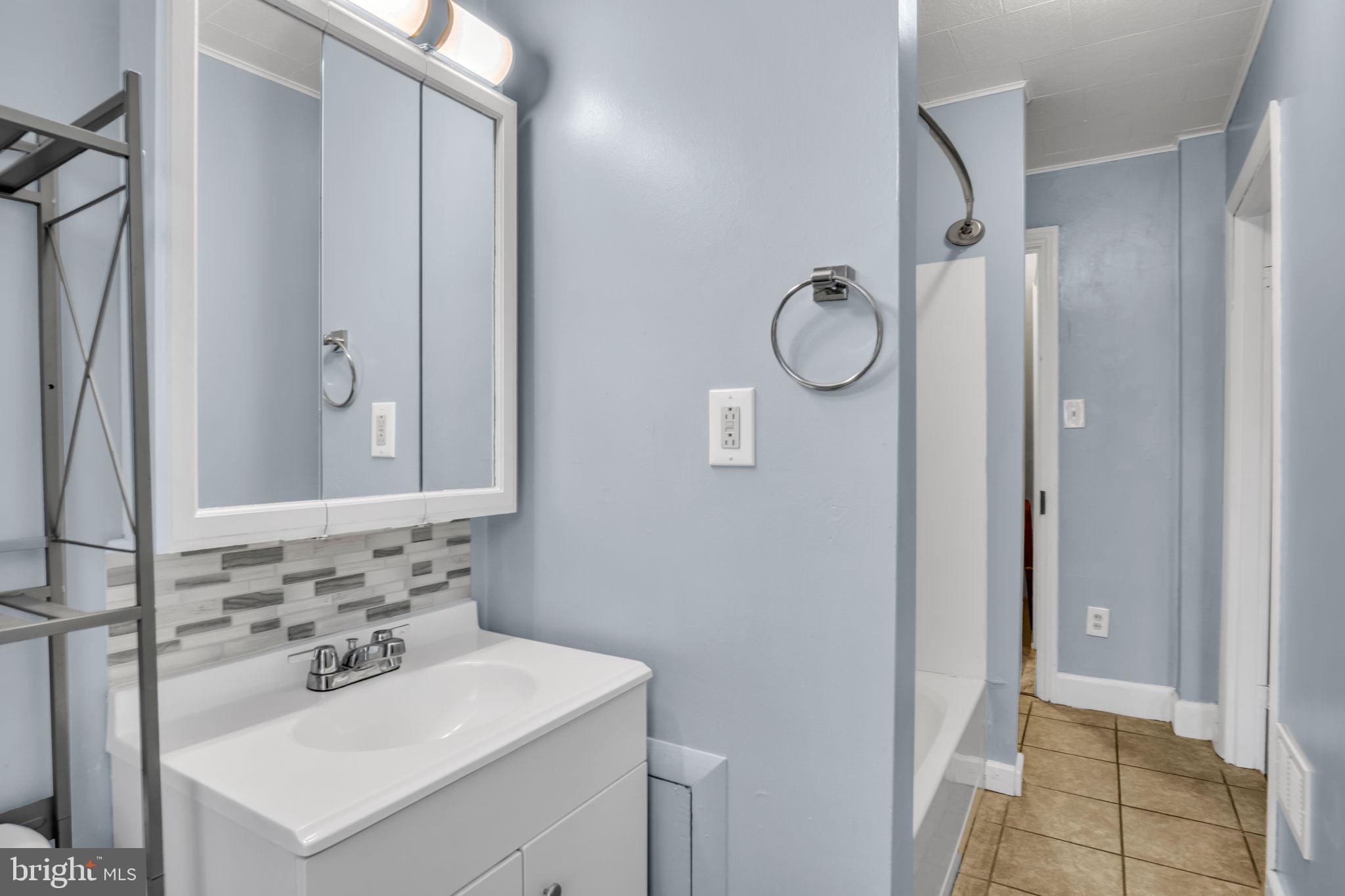 27 South Spring Garden Street Carlisle, PA 17013 - Photo 16 of 26 a bathroom with a sink mirror toilet and shower