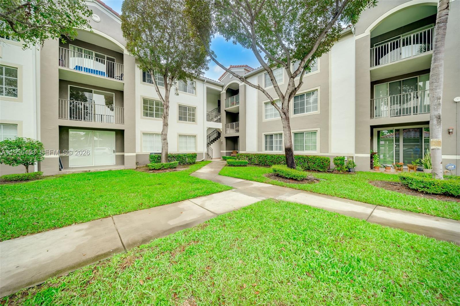6831 Southwest 44th Street, Unit 304 Miami, FL 33155 - Photo 20 of 27 a view of a building with a yard