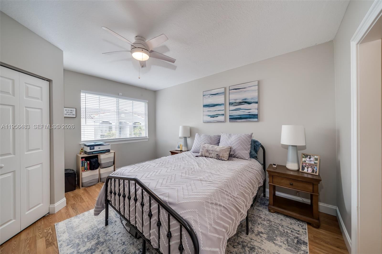 6831 Southwest 44th Street, Unit 304 Miami, FL 33155 - Photo 9 of 27 a bedroom with a bed a dresser with wooden floor