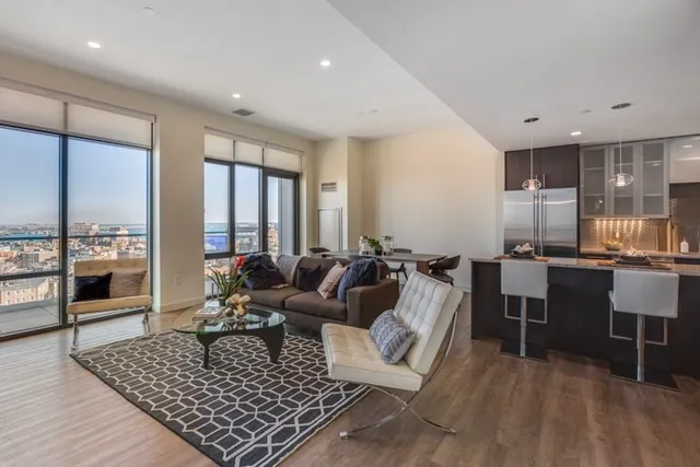 a living room with furniture rug and wooden floor