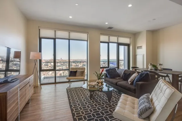 a living room with furniture and a large window