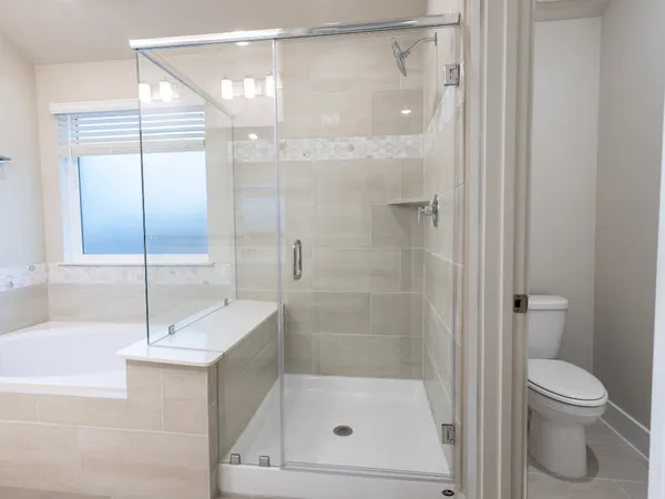 a bathroom with a tub a sink and a large mirror