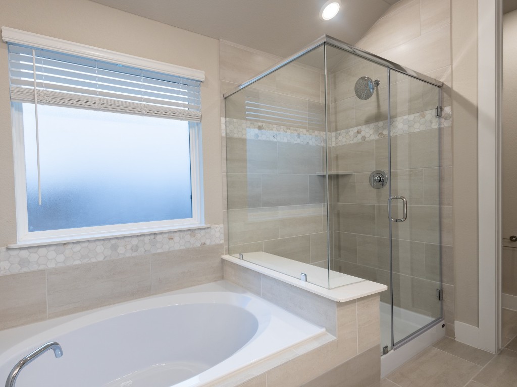 2010 Bluff Oak Street Conroe, TX 77304 - Photo 24 of 35 a bathroom with a shower and a bathtub