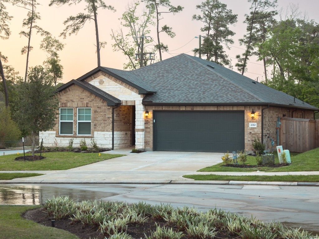 2010 Bluff Oak Street Conroe, TX 77304 - Photo 35 of 35 a front view of a house with a yard and garage