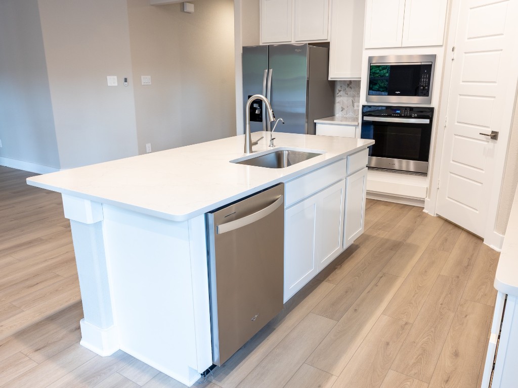 2010 Bluff Oak Street Conroe, TX 77304 - Photo 6 of 35 a kitchen with a sink and white cabinets