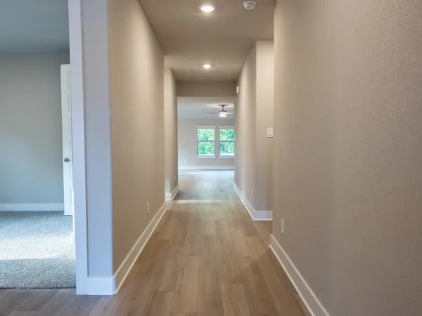 a view of hallway with wooden floor