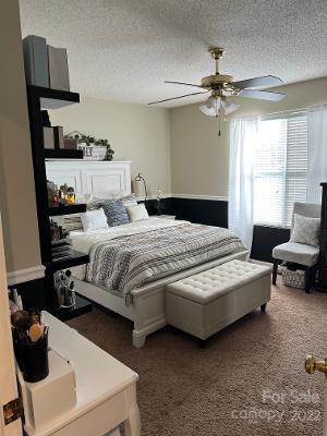 3474 Maiden Springs Road Maiden, NC 28650 - Photo 11 of 30 a bedroom with a bed and a chandelier