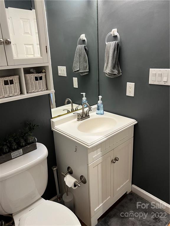 3474 Maiden Springs Road Maiden, NC 28650 - Photo 18 of 30 a bathroom with a sink a toilet and a mirror