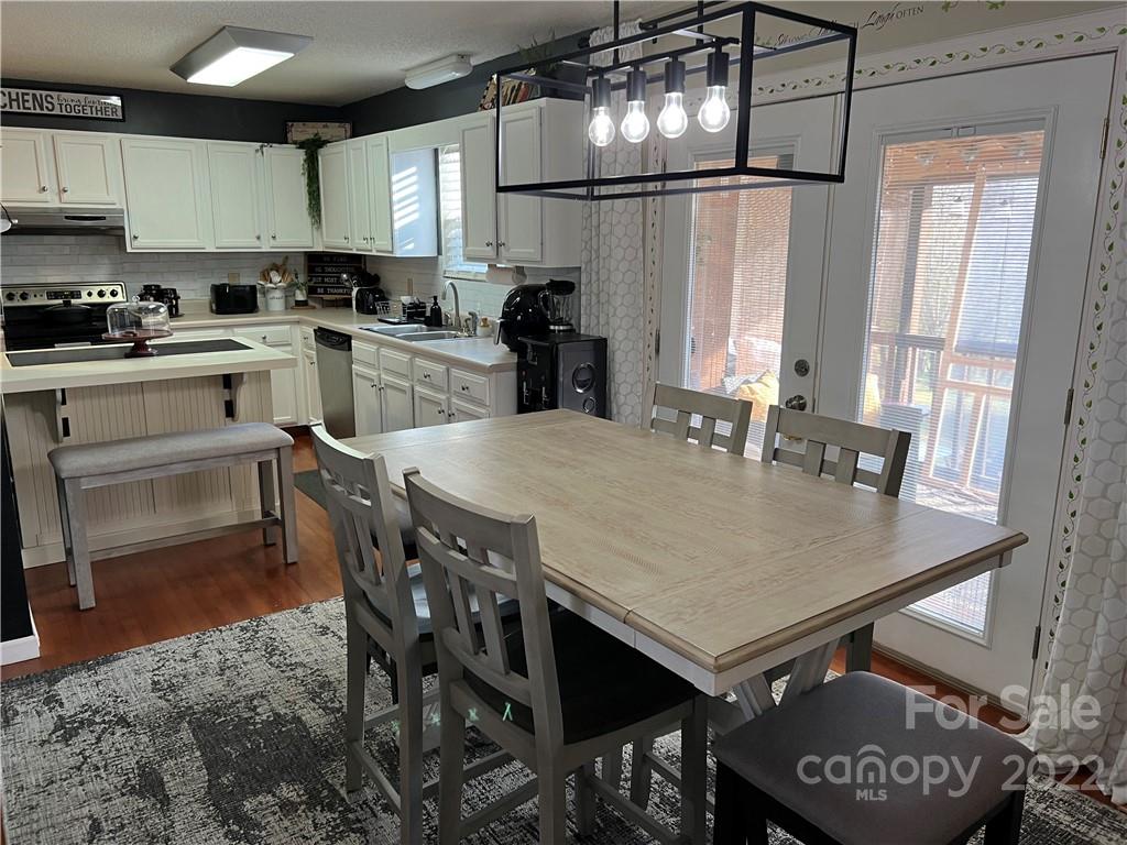 3474 Maiden Springs Road Maiden, NC 28650 - Photo 9 of 30 a kitchen with a dining table chairs and refrigerator