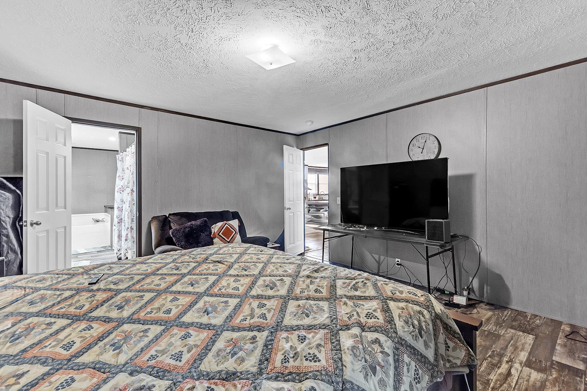 664 Rialto Road Covington, TN 38019 - Photo 11 of 22 Bedroom with a textured ceiling and wood finished floors