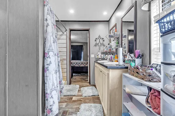 a very nice looking dining room with a large mirror and sink