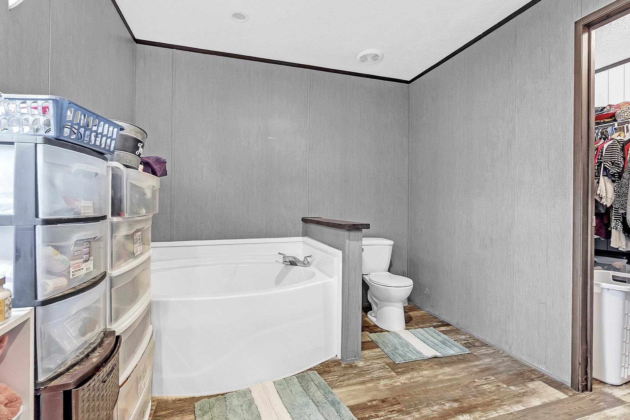 664 Rialto Road Covington, TN 38019 - Photo 14 of 22 Full bath with a garden tub and light wood-style flooring