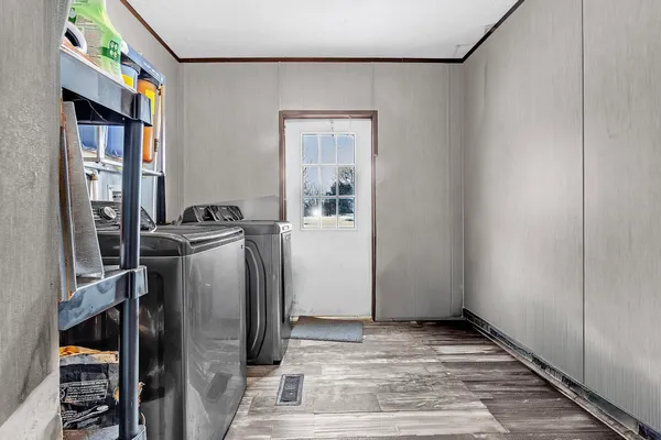 a view of a storage & utility room with refrigerator and washer