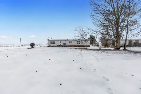 a view of a yard with snow on the road