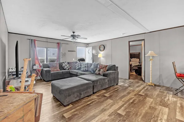 a bedroom with furniture and a flat screen tv