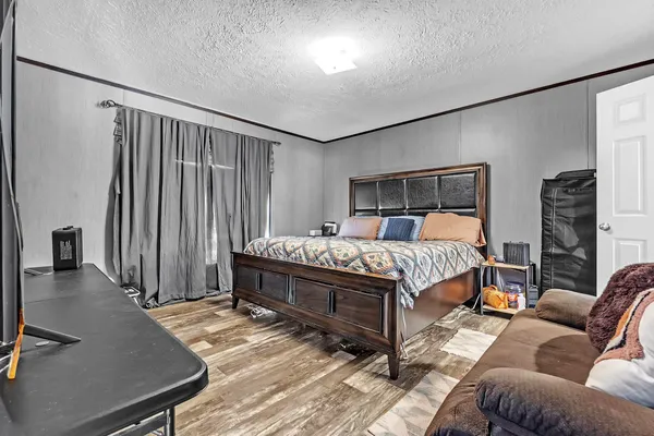 a bedroom with a bed couch and a window