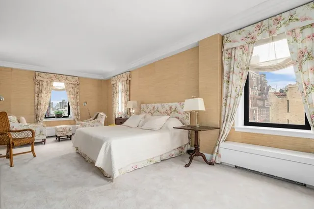 a spacious bedroom with a bed and a window