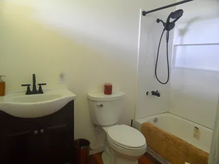 a bedroom with a bed and a dresser in it