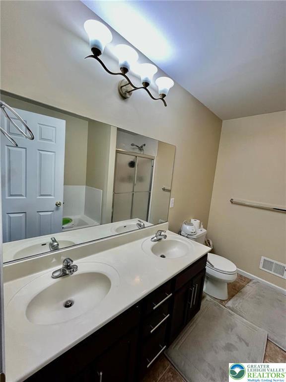 4164 Ross Road Bethlehem, PA 18020 - Photo 10 of 13 a bathroom with a double vanity sink mirror and toilet