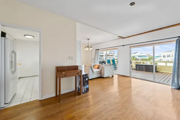 a living room with furniture and a dining table