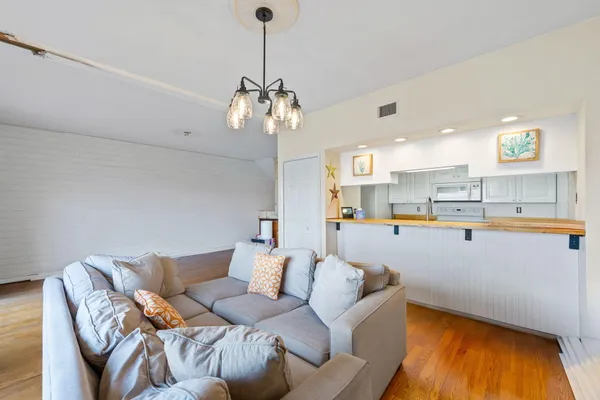 a view of a balcony with wooden floor and outdoor seating